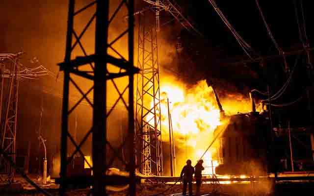 Firefighters battle flames after a Russian rocket attack hit an electric power station in Kharkiv